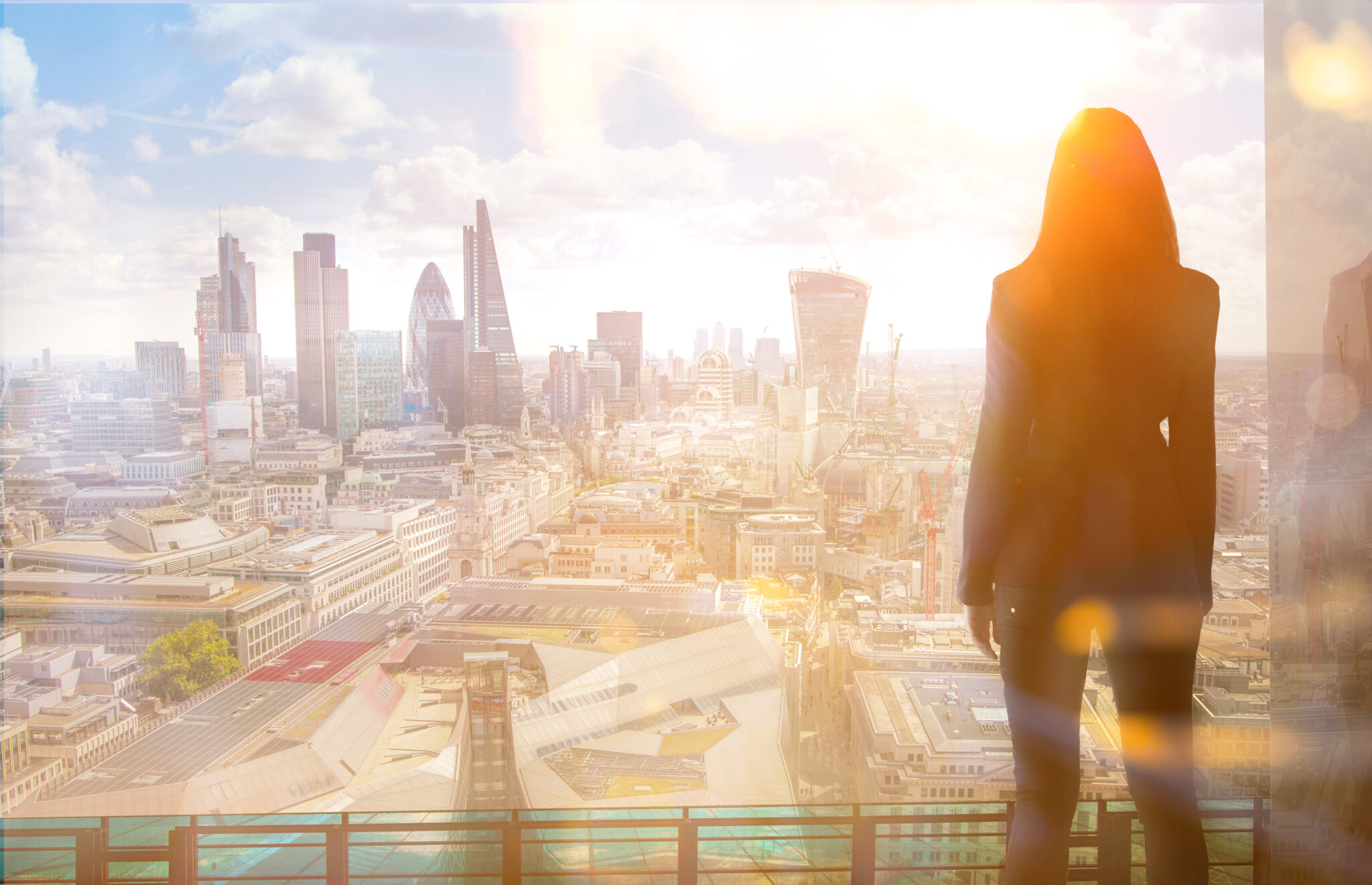 Young,Woman,Looking,Over,The,City,Of,London,At,Sun
